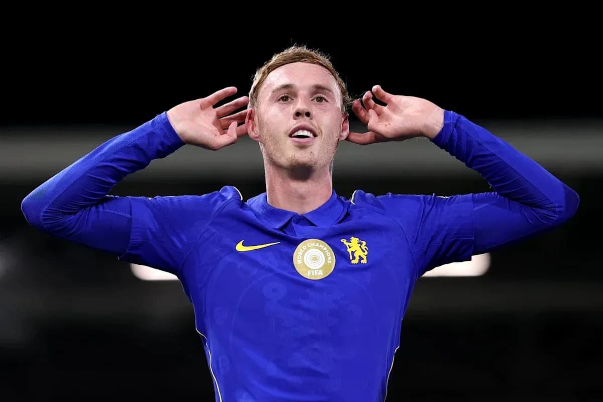 Player celebrating with hands on ears in blue kit Player celebrating with hands on ears in blue kit
