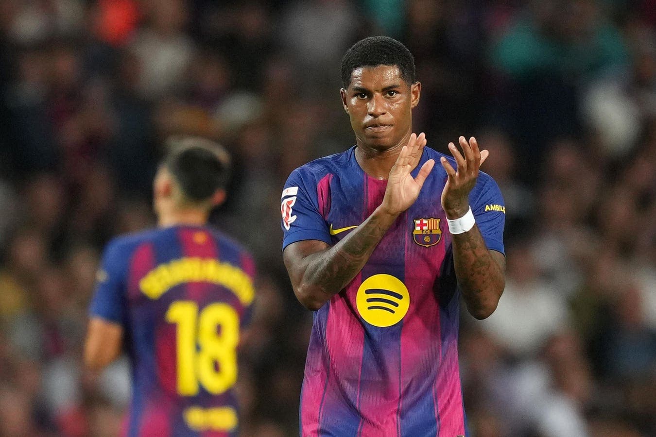 Player applauding during match with teammate behind Player applauding during match with teammate behind