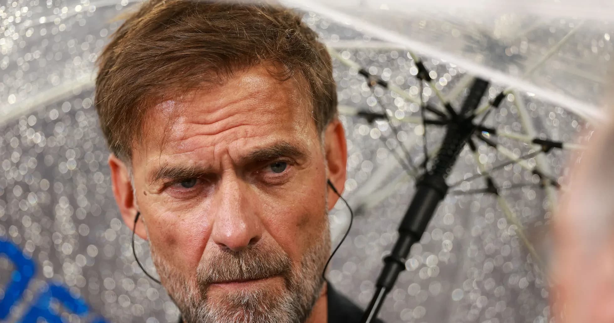 Coach speaking under an umbrella during rain Coach speaking under an umbrella during rain