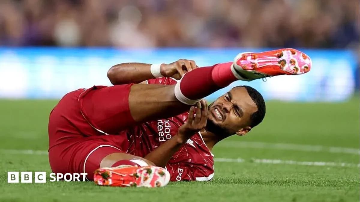 Player lying on the ground with injured leg Player lying on the ground with injured leg