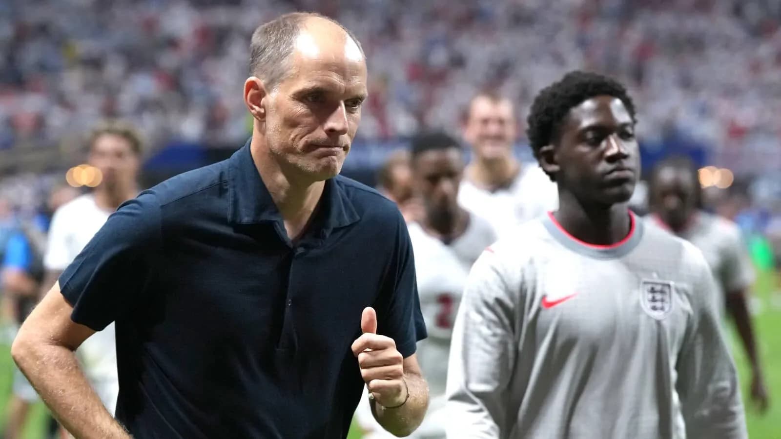 Manager walking off field with players after match Manager walking off field with players after match