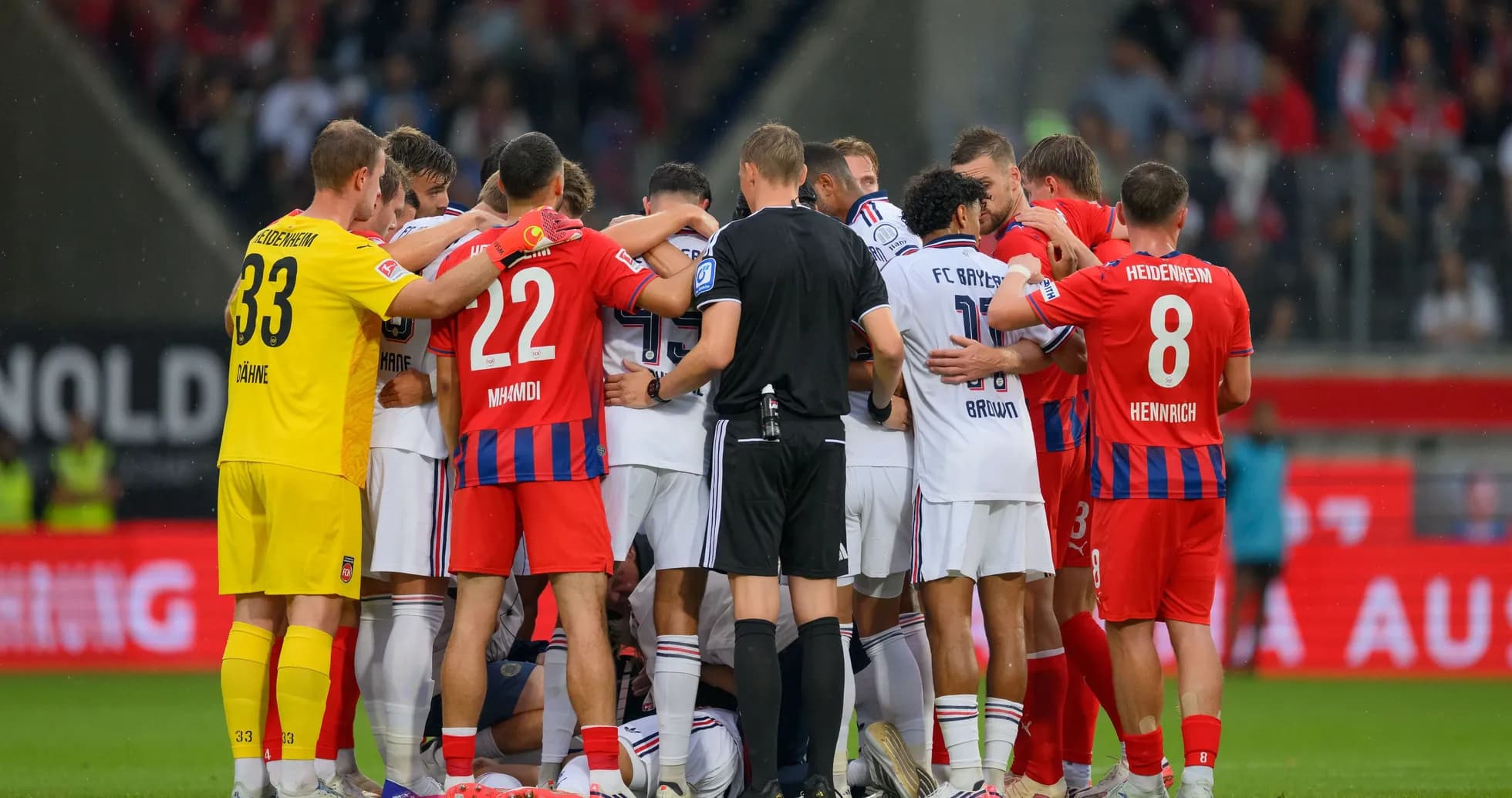 Players from both teams huddled together during match Players from both teams huddled together during match