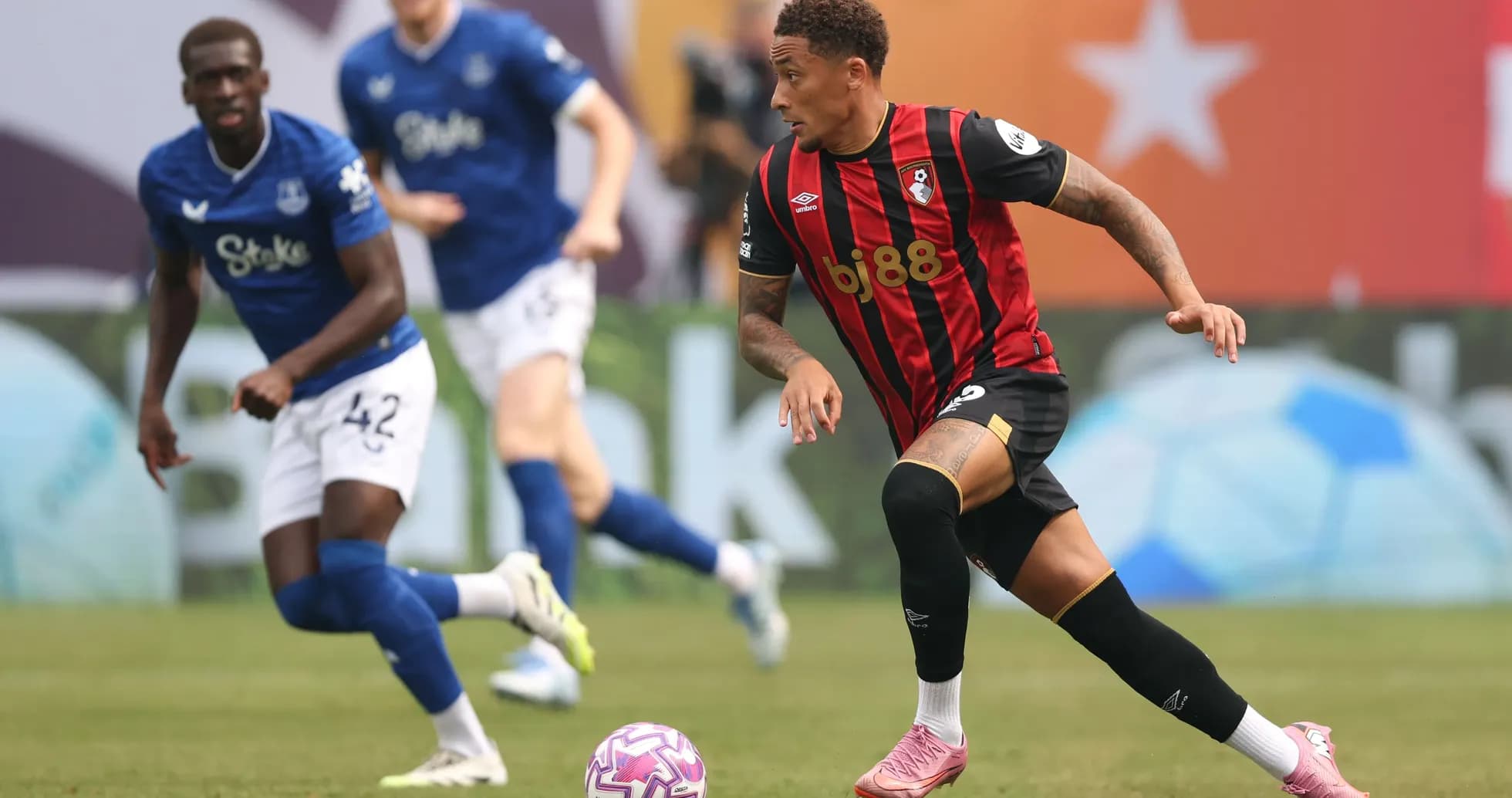 Bournemouth player dribbling past Everton defender on pitch Bournemouth player dribbling past Everton defender on pitch