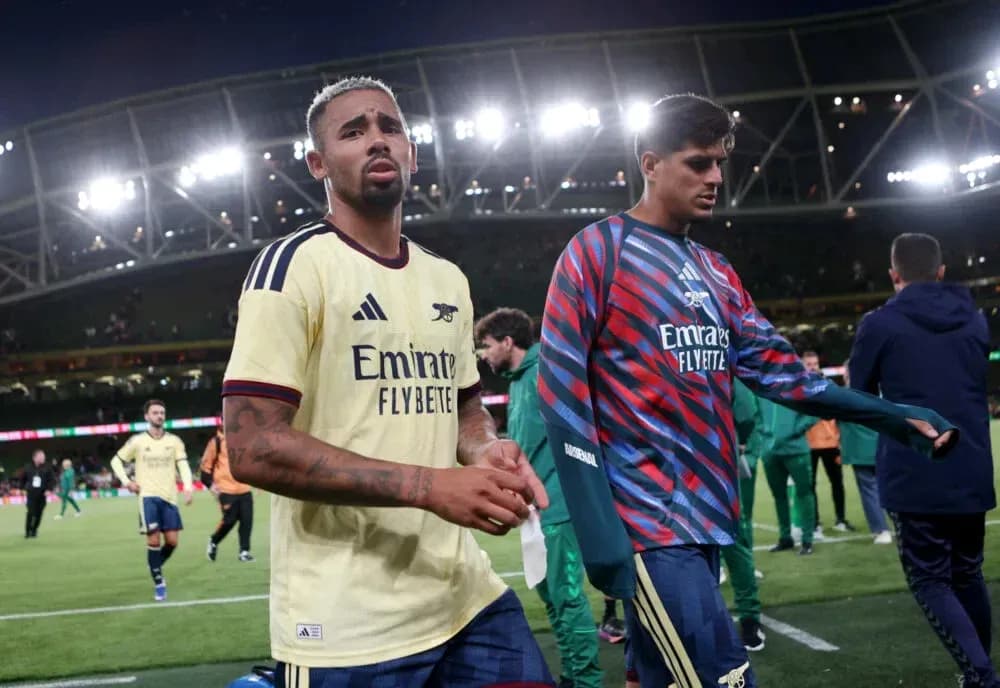 Two Arsenal players walking off the pitch Two Arsenal players walking off the pitch