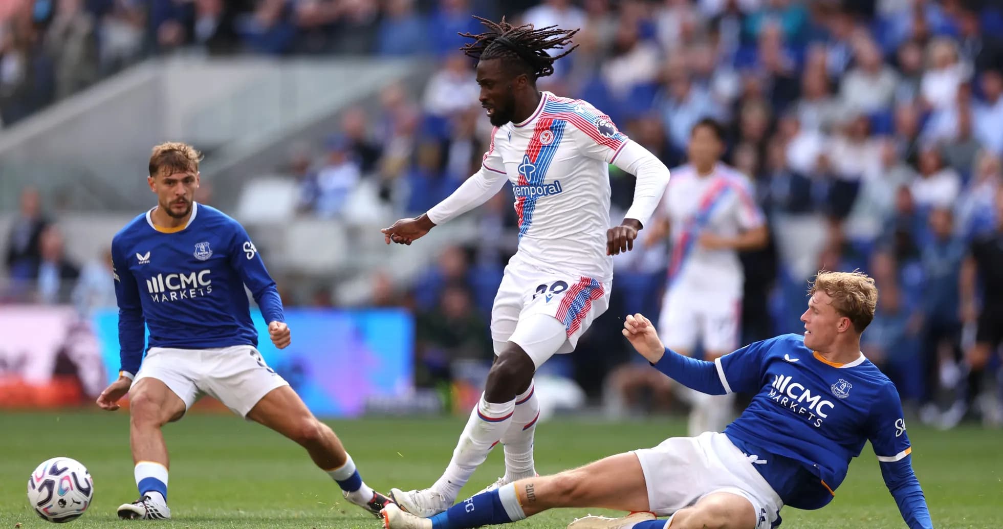 Player dribbling past opponents during a match Player dribbling past opponents during a match