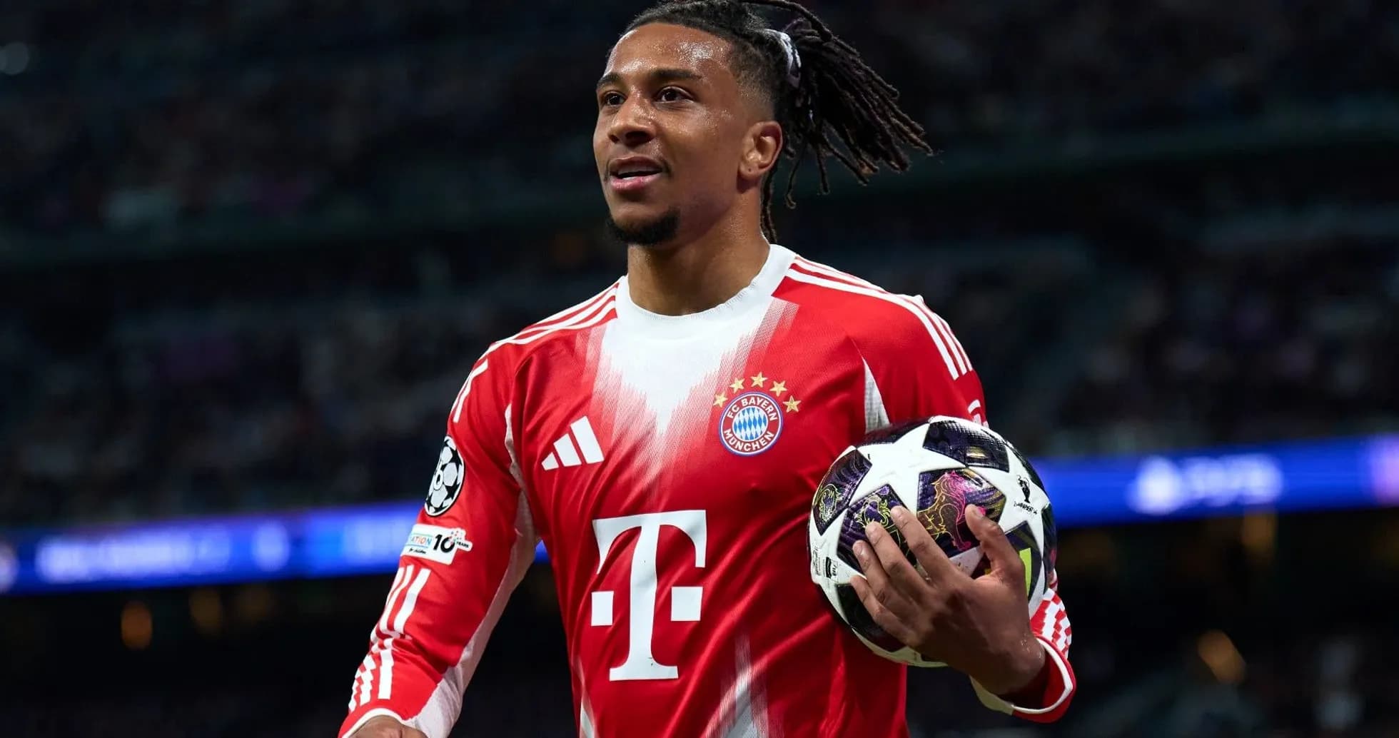 Player holding a Champions League ball on field Player holding a Champions League ball on field