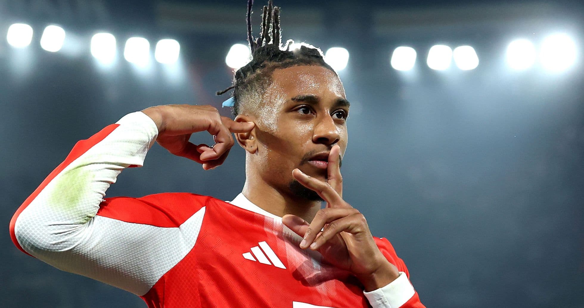 Player celebrating a goal with a shushing gesture Player celebrating a goal with a shushing gesture