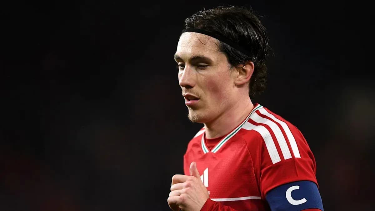 Player wearing red jersey with captain's armband Player wearing red jersey with captain's armband