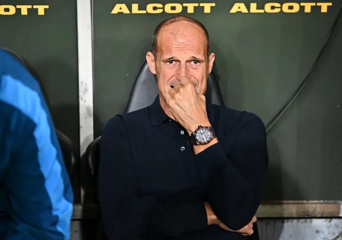 Coach sitting on bench during match, looking concerned Coach sitting on bench during match, looking concerned