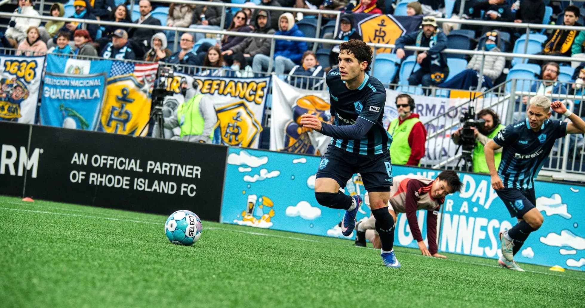 Player running with ball during Rhode Island match Player running with ball during Rhode Island match