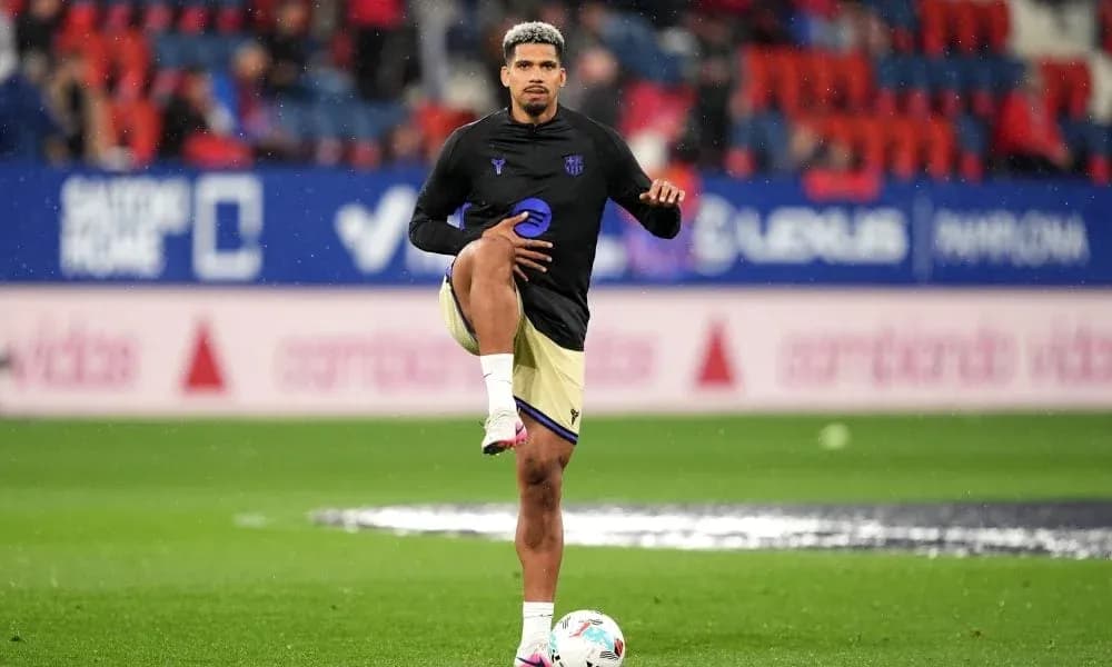 Player stretching during warm-up on the pitch Player stretching during warm-up on the pitch