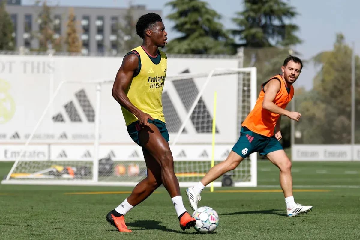 Two players training on pitch with goal in background Two players training on pitch with goal in background