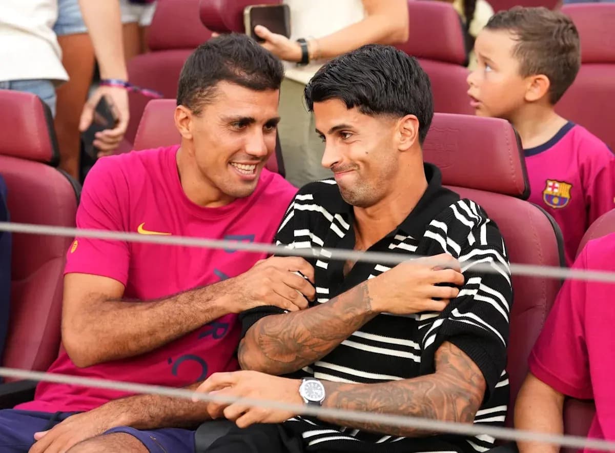Two players chatting in stadium seats during event Two players chatting in stadium seats during event