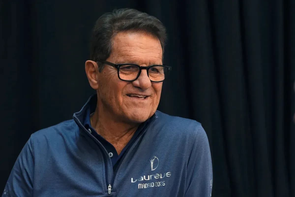 Man smiling during a press conference appearance Man smiling during a press conference appearance