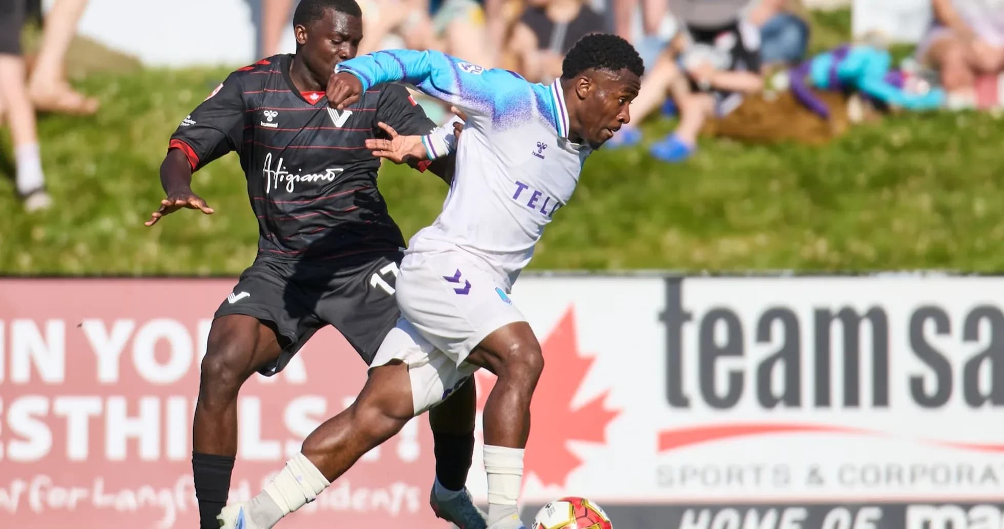 Player from Pacific FC dribbling against Vancouver FC Player from Pacific FC dribbling against Vancouver FC