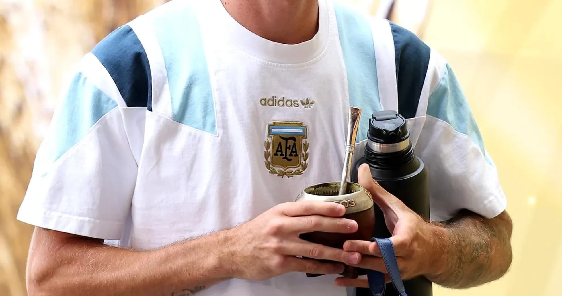 Player holding mate and water bottle, wearing Argentina jersey Player holding mate and water bottle, wearing Argentina jersey