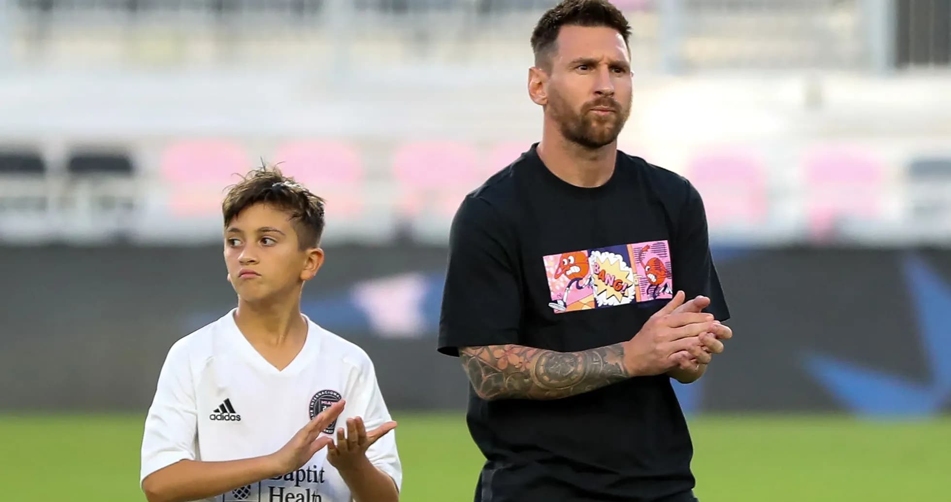 Lionel Messi and a child applauding on field Lionel Messi and a child applauding on field