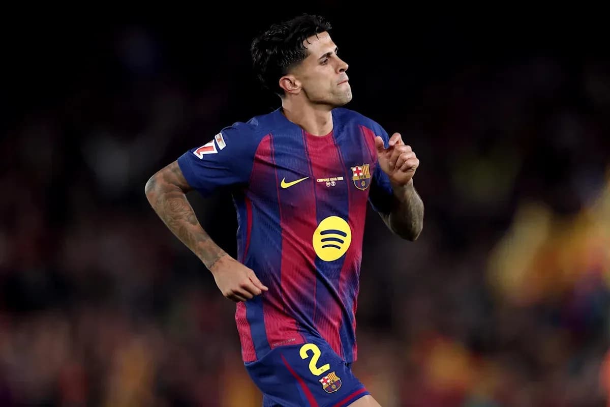 Player in FC Barcelona kit running on field Player in FC Barcelona kit running on field