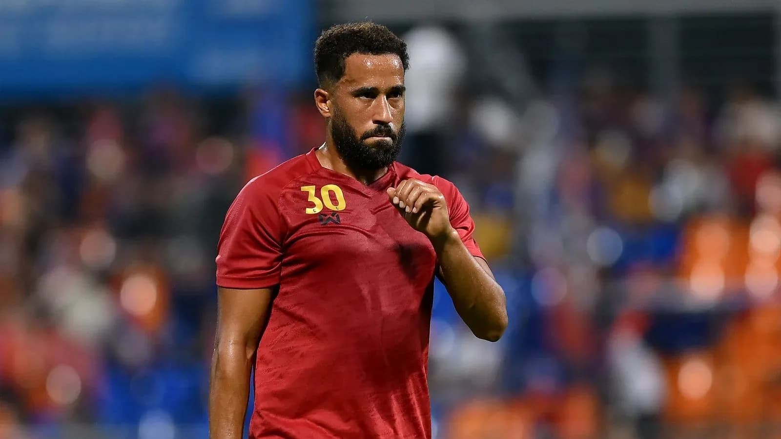 Player in red jersey gesturing on the field Player in red jersey gesturing on the field