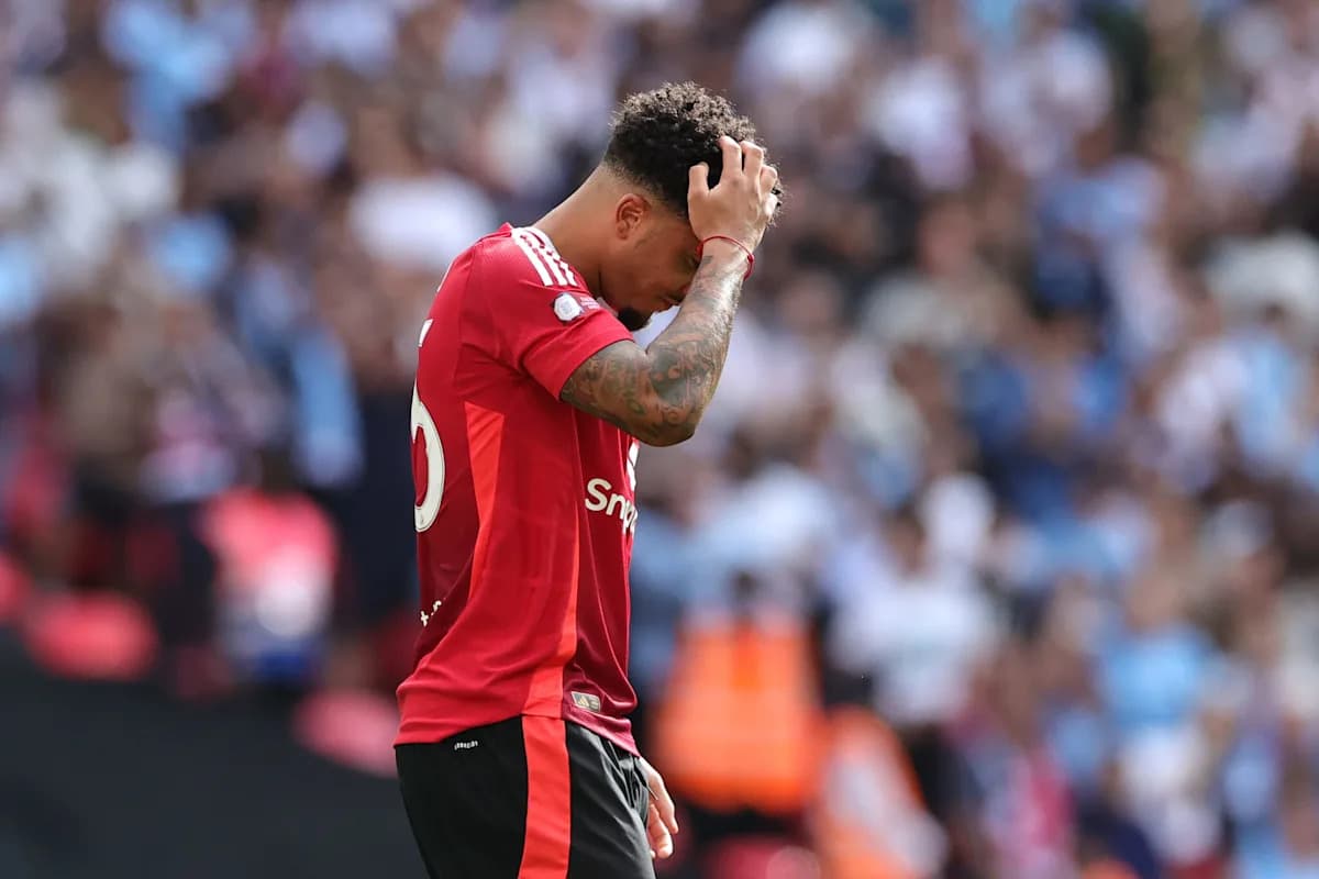 Player in red jersey looks dejected on field Player in red jersey looks dejected on field