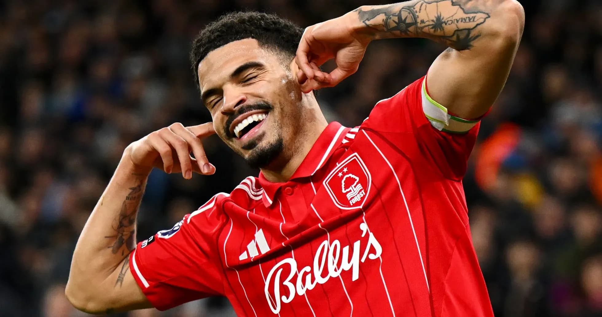 Player celebrating a goal in red team jersey Player celebrating a goal in red team jersey