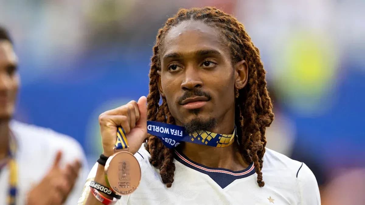 Player holding FIFA World Cup bronze medal Player holding FIFA World Cup bronze medal