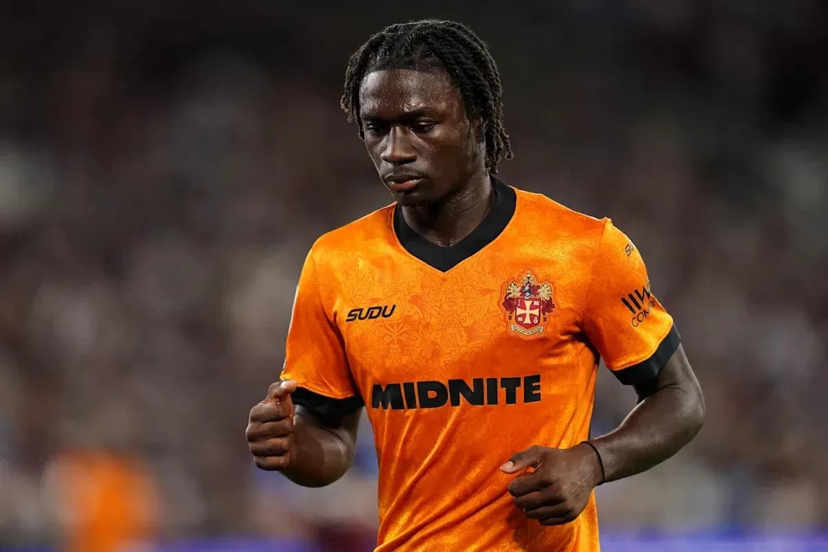 Player in orange jersey walking on the pitch Player in orange jersey walking on the pitch