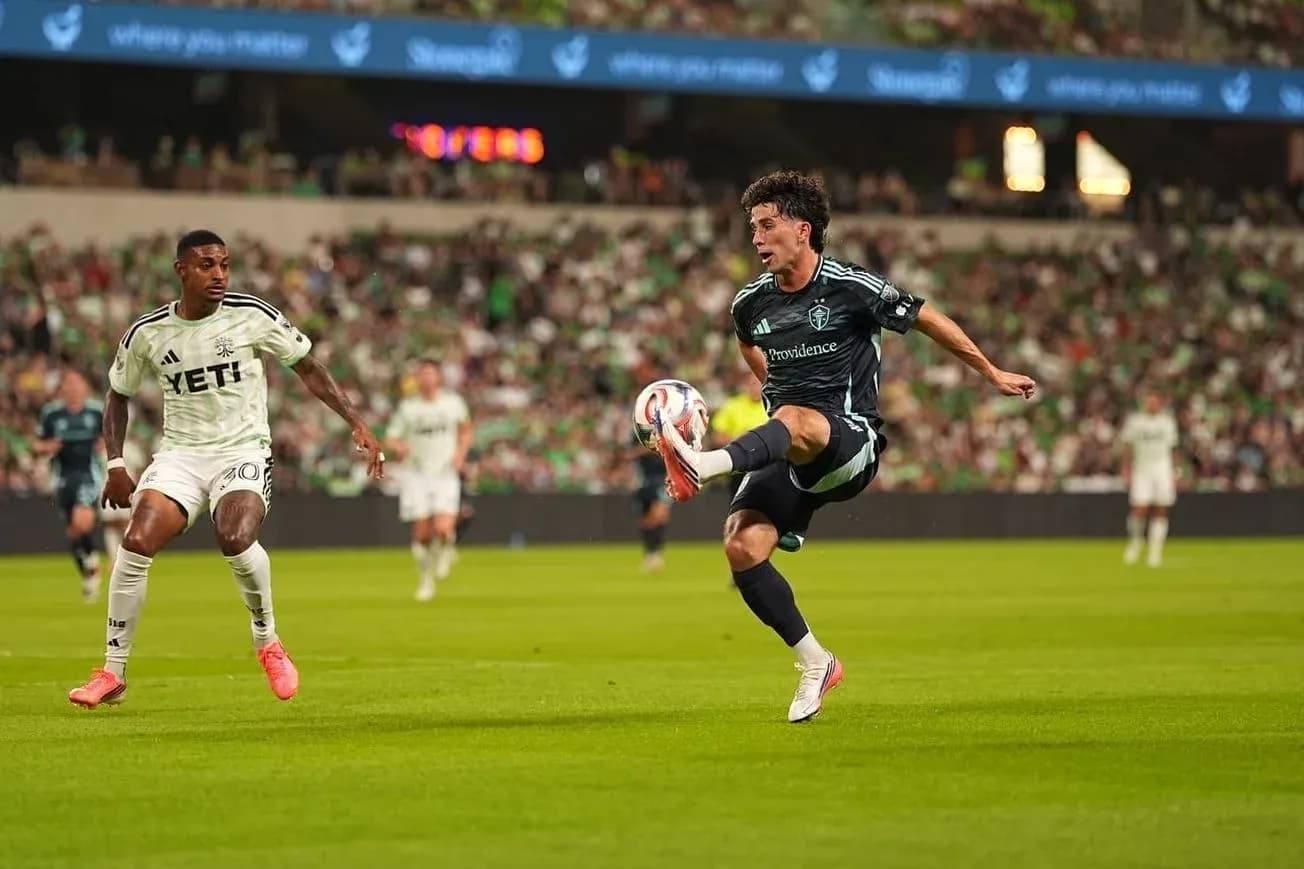 Player kicking ball during Seattle Sounders match Player kicking ball during Seattle Sounders match