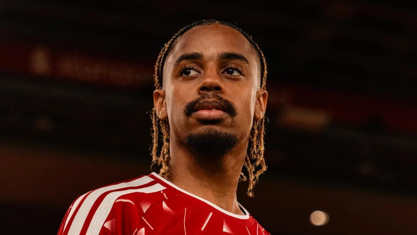 Player wearing red jersey, looking focused Player wearing red jersey, looking focused