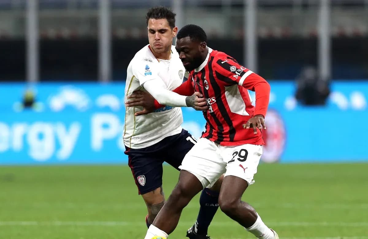 AC Milan player battling with Cagliari opponent AC Milan player battling with Cagliari opponent