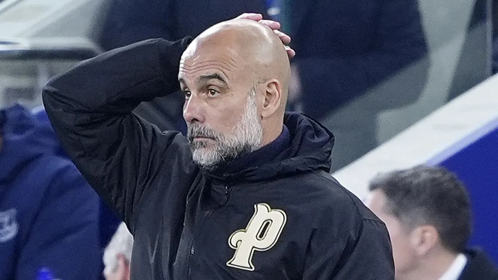 Coach observing match with hand on head Coach observing match with hand on head