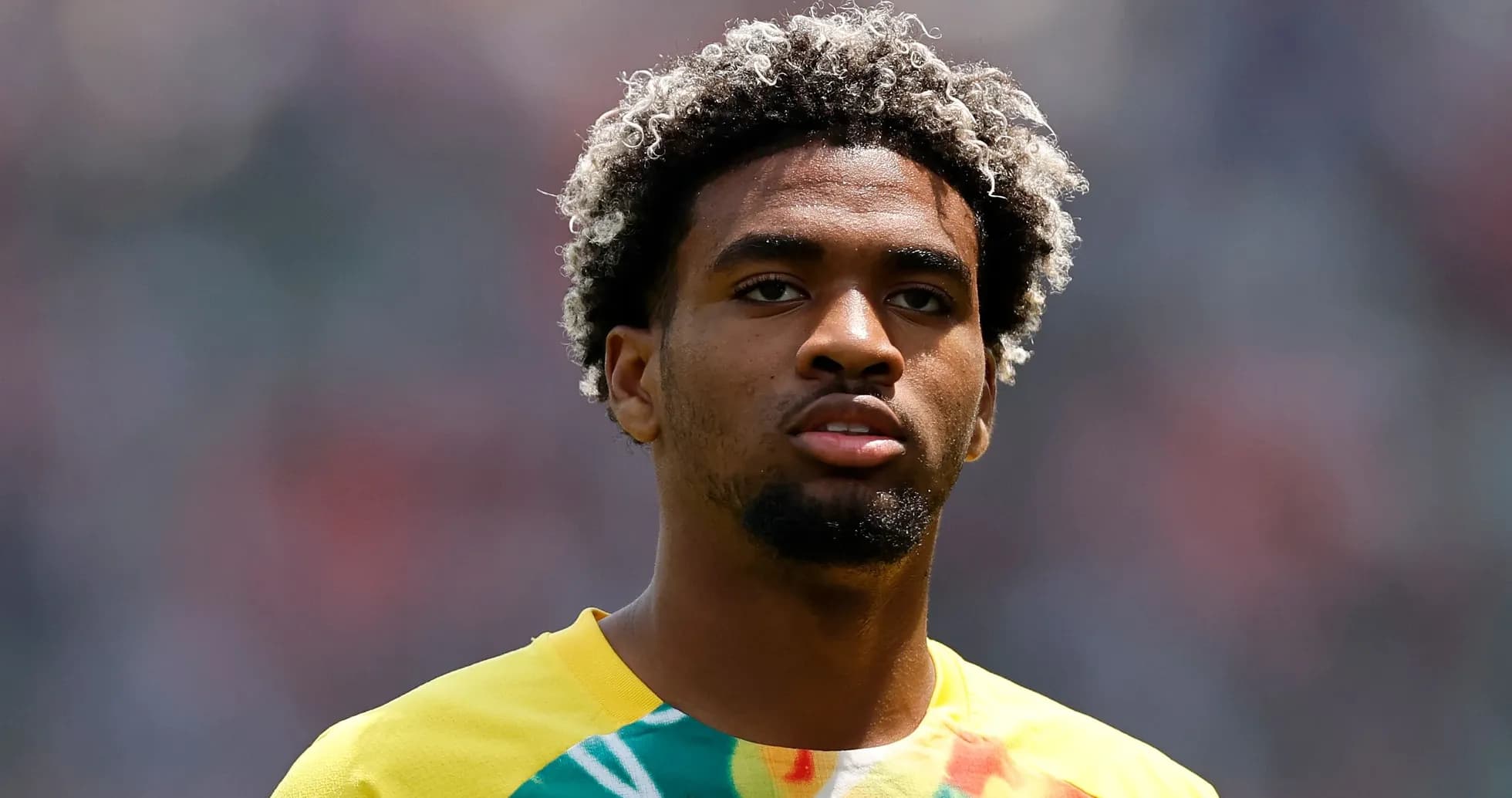 Player with curly hair in colorful training shirt Player with curly hair in colorful training shirt
