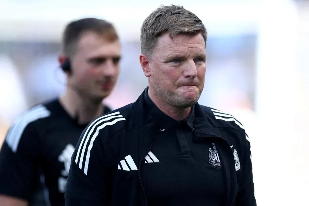 Manager walking off the pitch with staff member Manager walking off the pitch with staff member