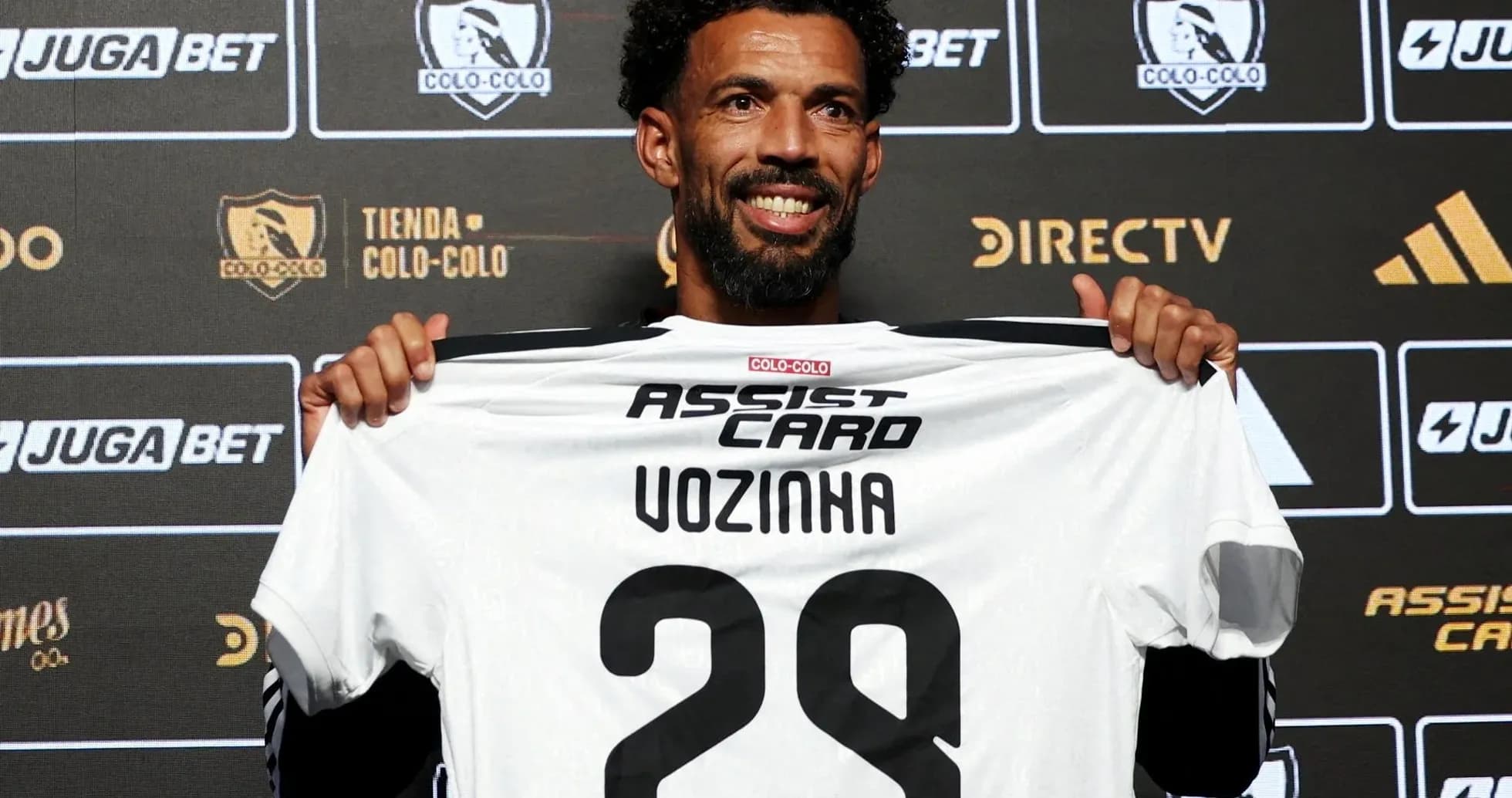 Player holding Colo-Colo jersey at press conference Player holding Colo-Colo jersey at press conference