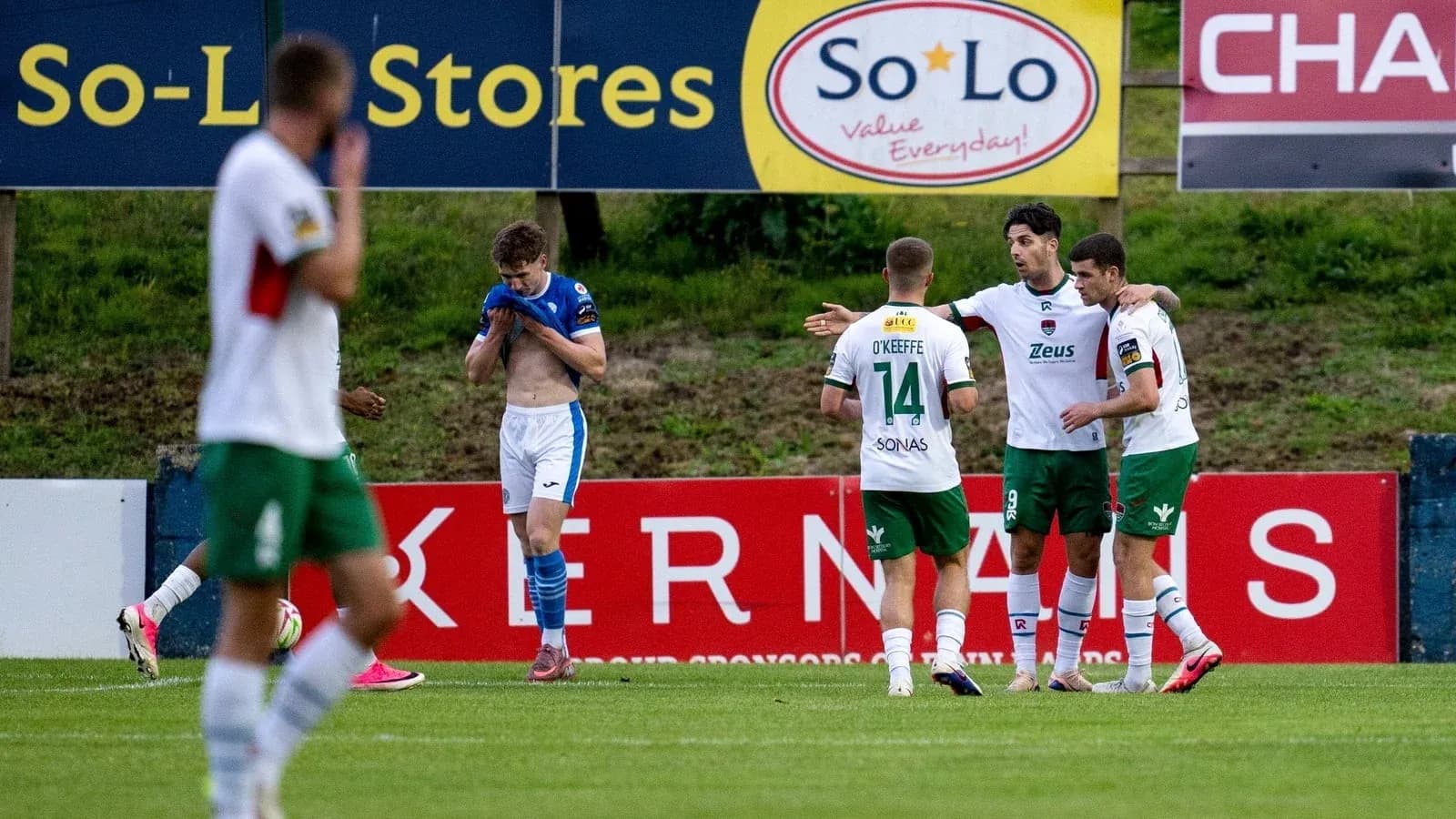 Players celebrating a goal on the field Players celebrating a goal on the field