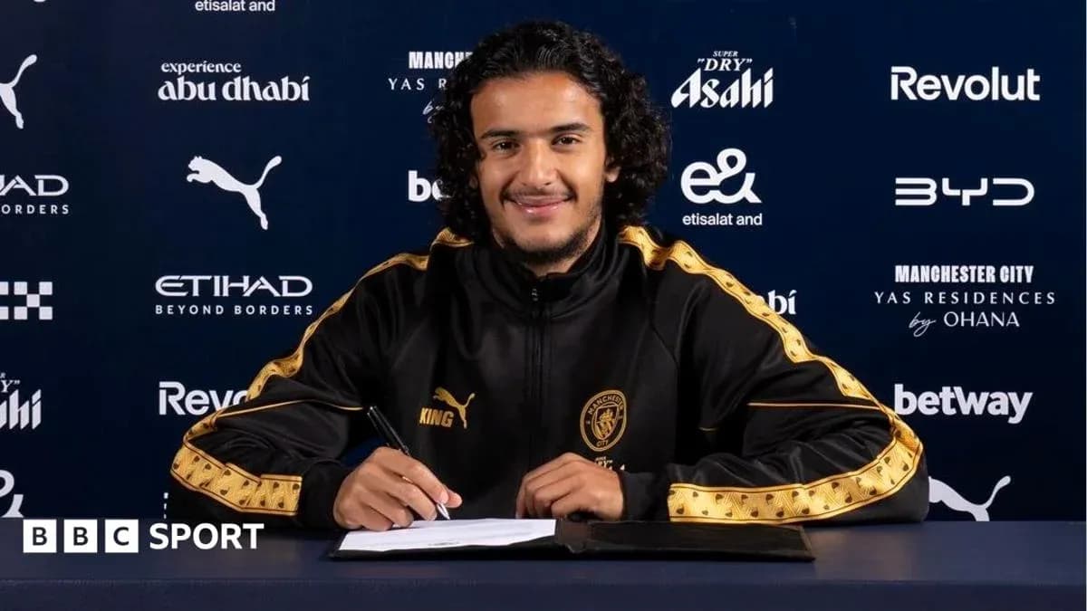 Player signing contract at press conference table Player signing contract at press conference table