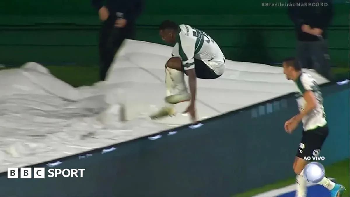 Player jumping over advertising board during match Player jumping over advertising board during match
