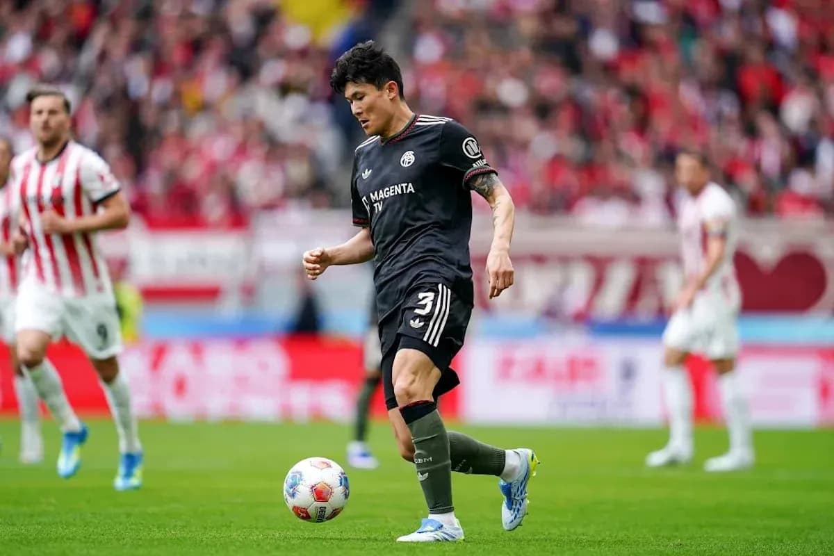 Player dribbling the ball during a soccer match Player dribbling the ball during a soccer match