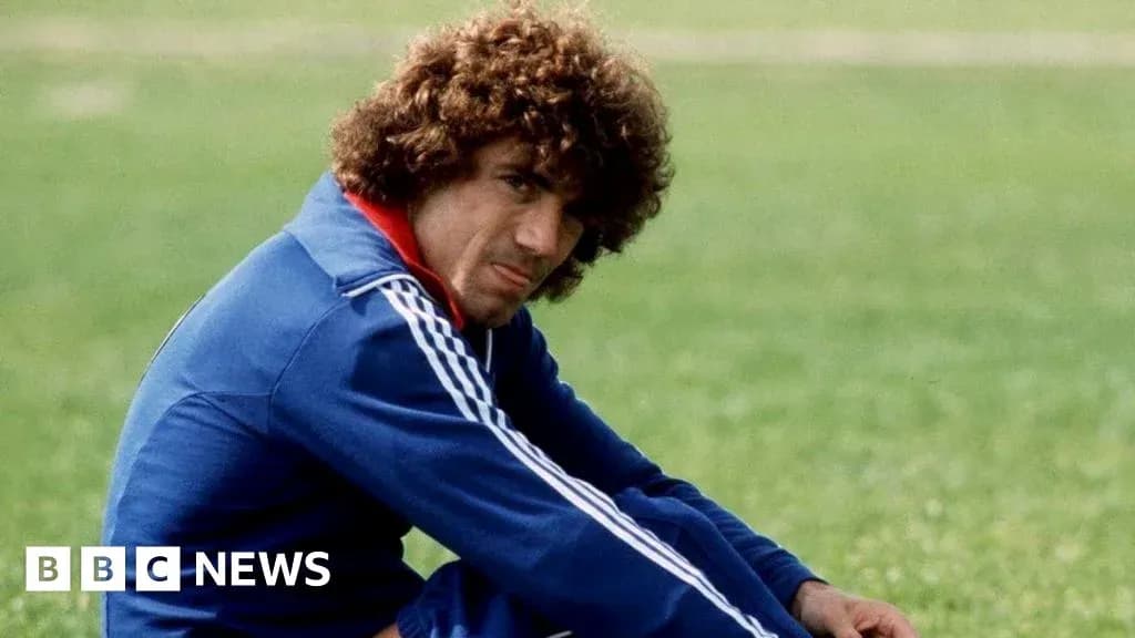 Football player sitting on grass during training Football player sitting on grass during training