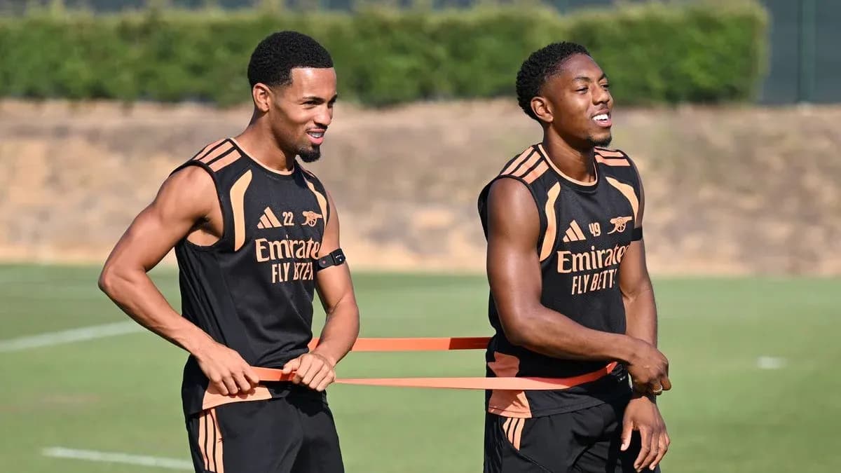 Two players training with resistance bands on pitch Two players training with resistance bands on pitch