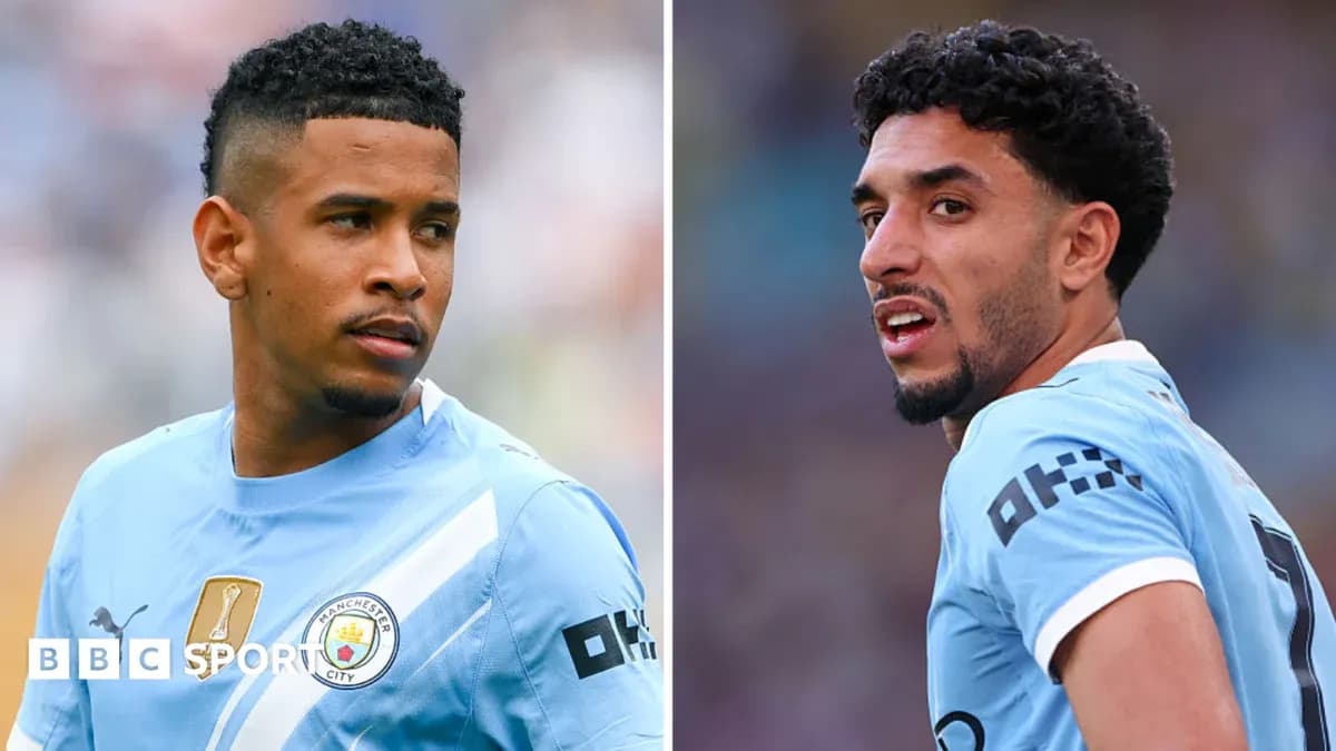Two Manchester City players in training kits Two Manchester City players in training kits