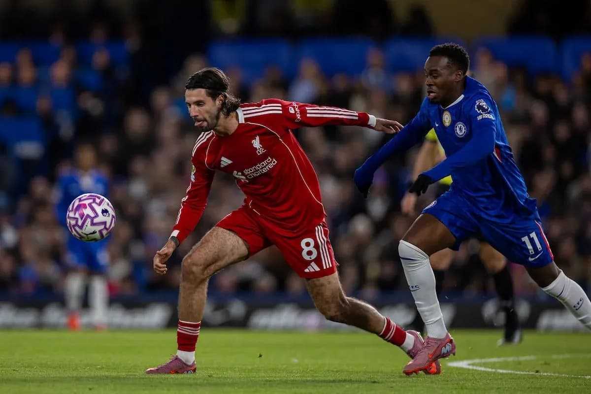 Liverpool player challenges Chelsea opponent for the ball Liverpool player challenges Chelsea opponent for the ball
