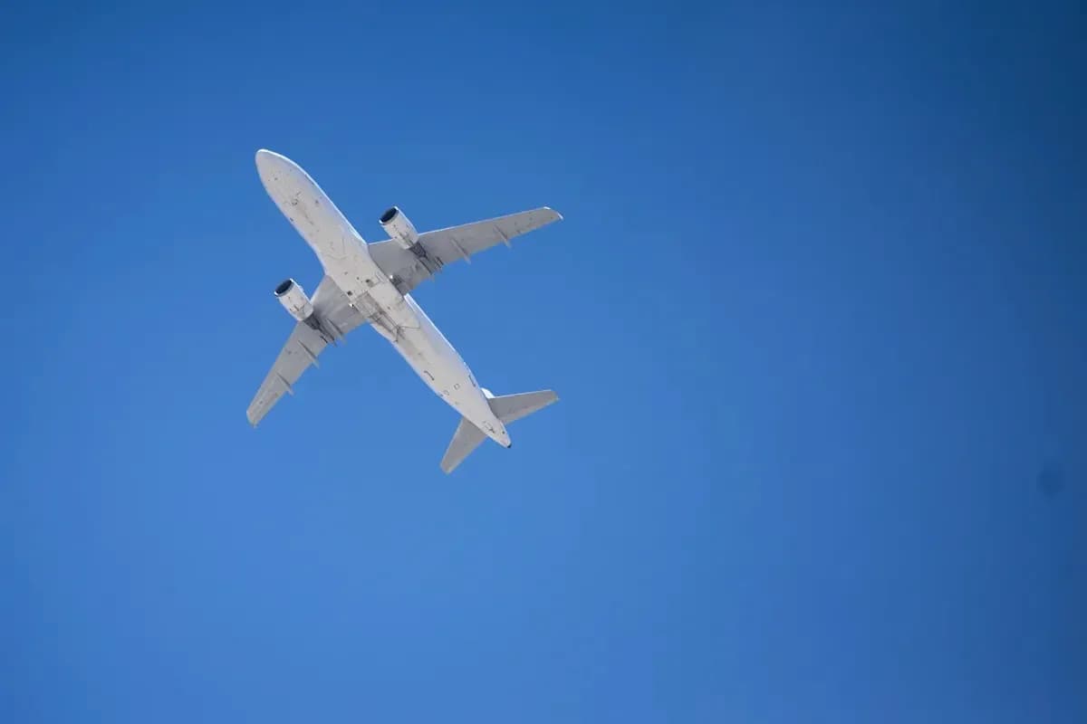 Commercial airplane flying against clear blue sky Commercial airplane flying against clear blue sky