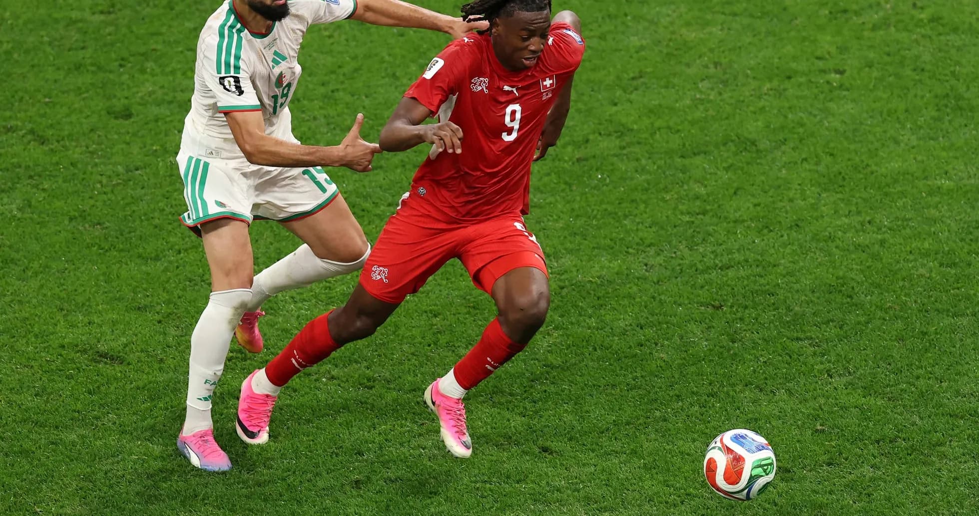 Player from Switzerland evading Algerian defender Player from Switzerland evading Algerian defender