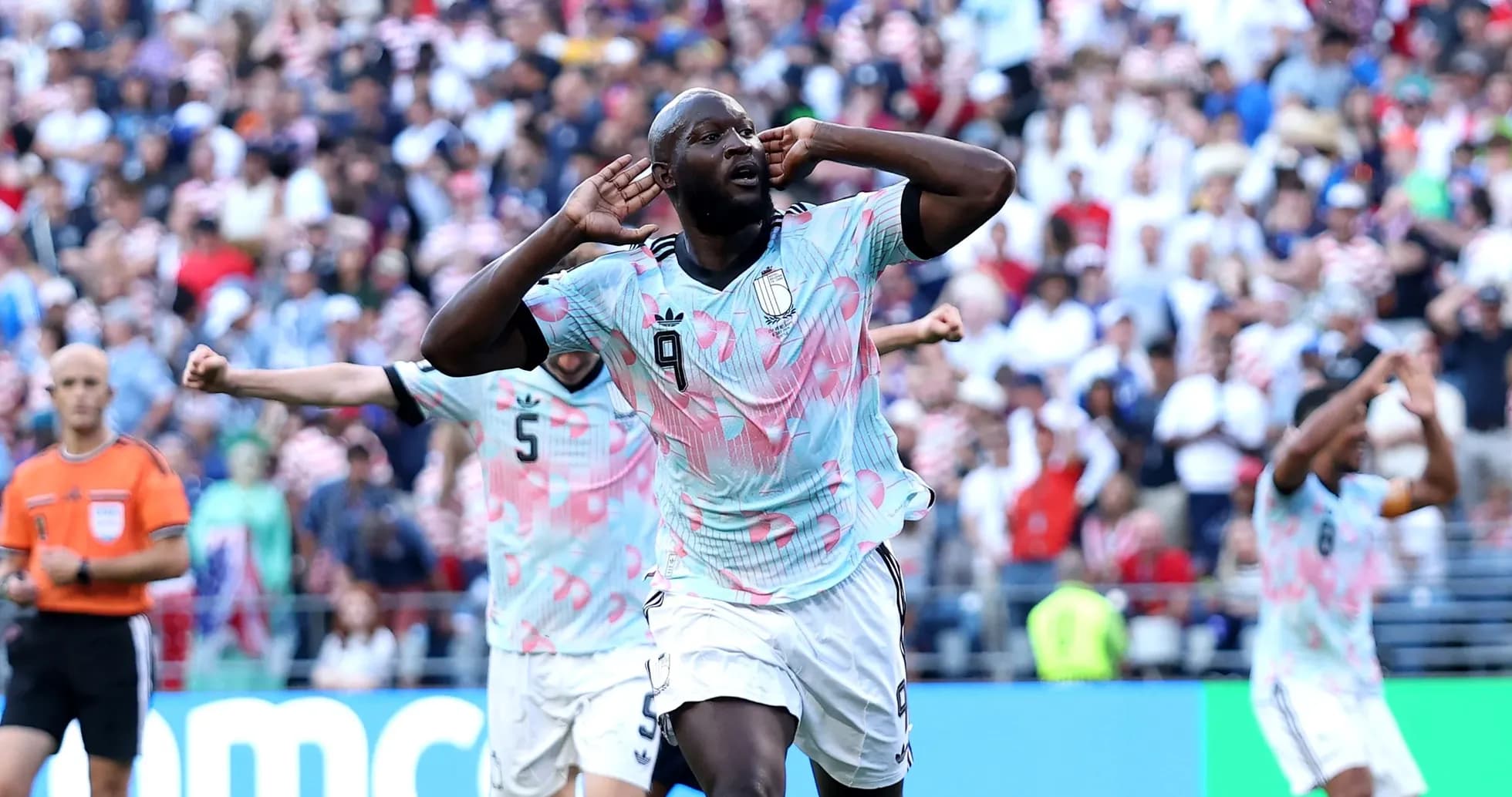 Player celebrating a goal with hands to ears Player celebrating a goal with hands to ears