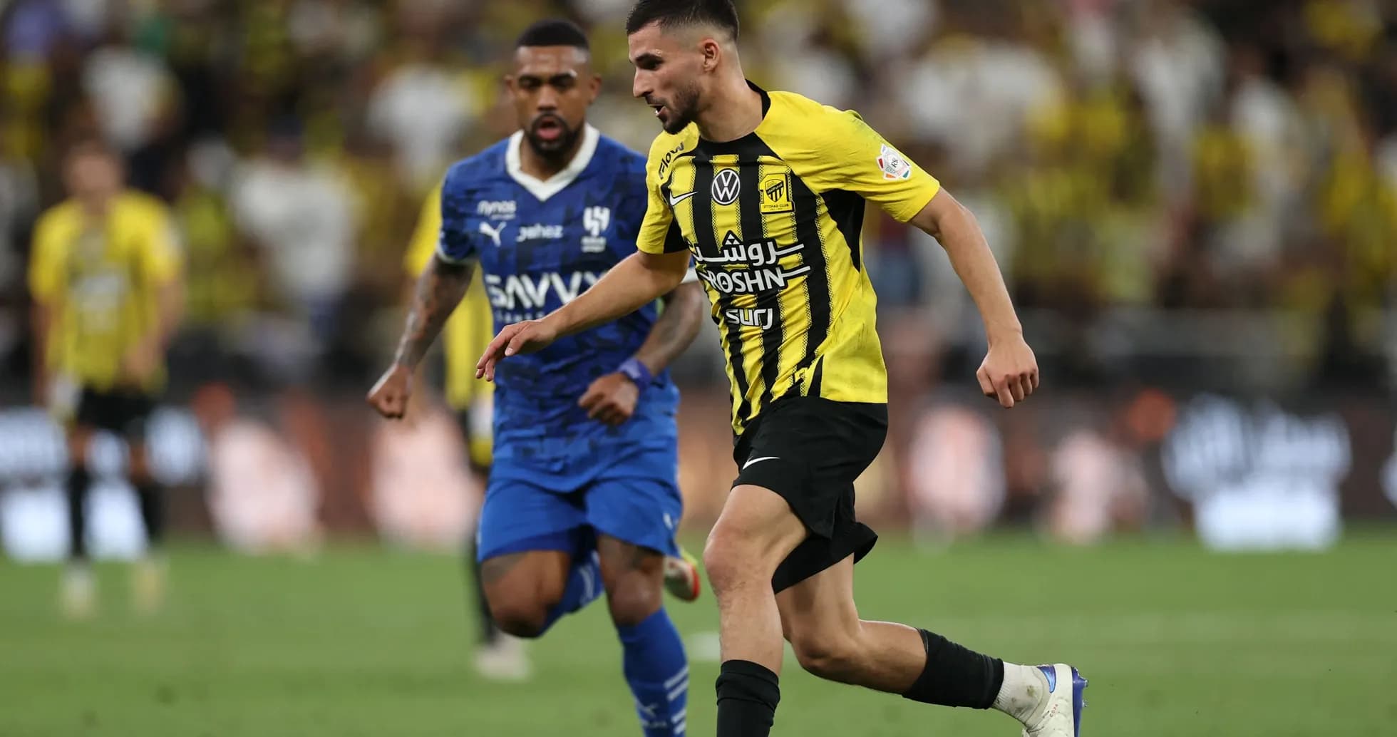 Player in yellow jersey dribbling the ball during match Player in yellow jersey dribbling the ball during match