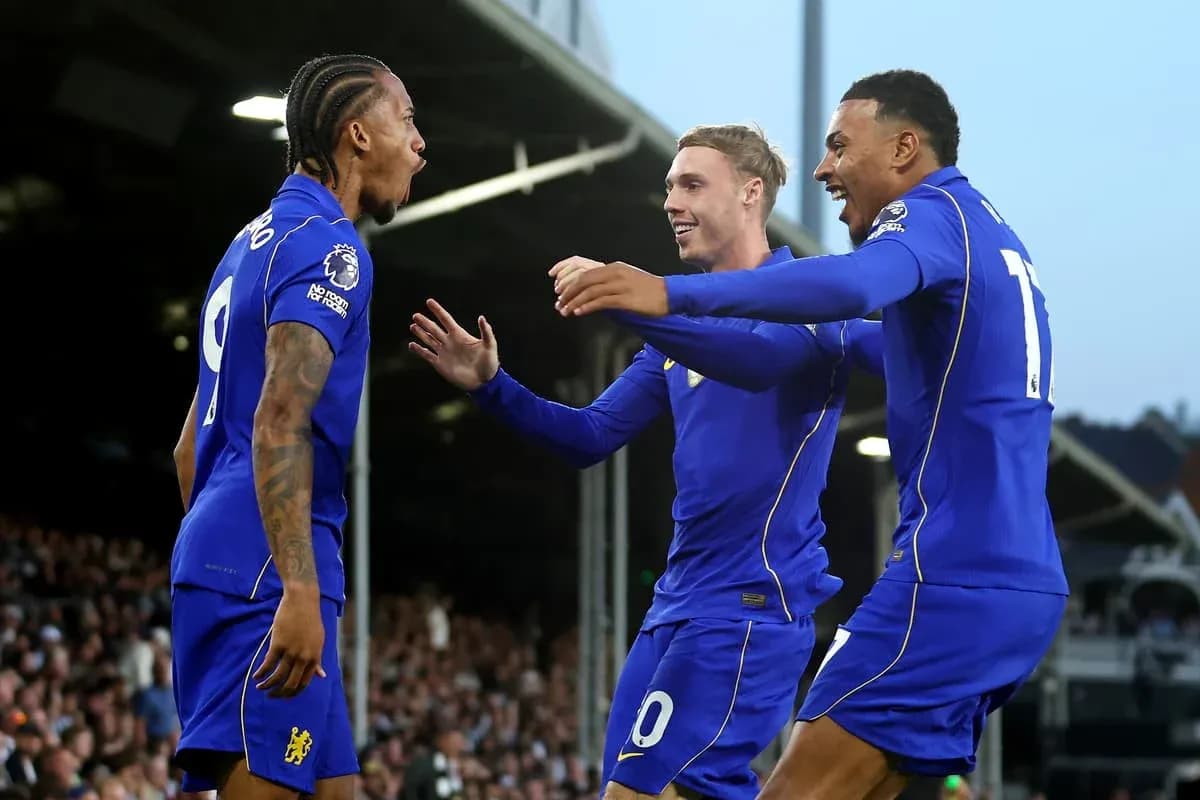 Three players celebrating a goal on the field Three players celebrating a goal on the field