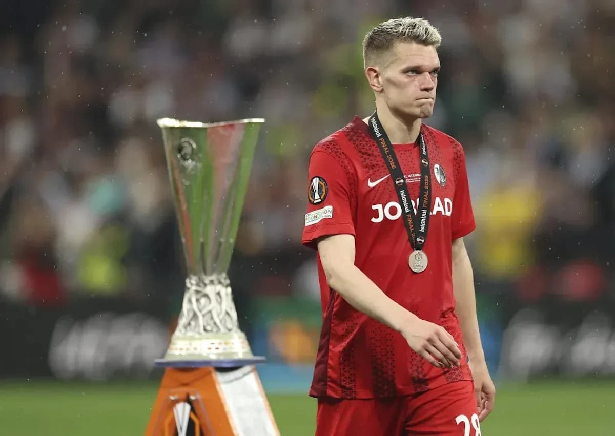 Player walking past UEFA trophy after match Player walking past UEFA trophy after match