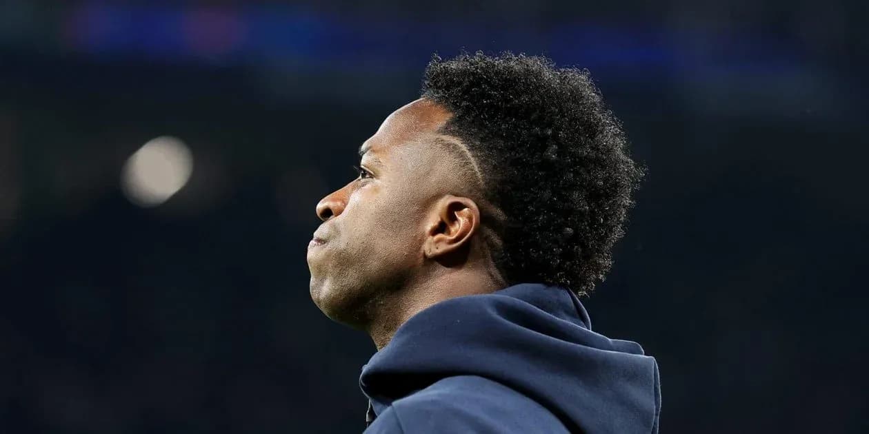 Player looking out during match, wearing hoodie Player looking out during match, wearing hoodie