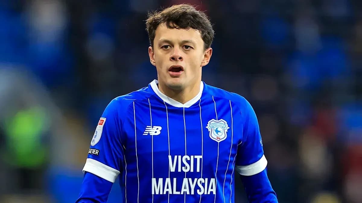 Football player in blue kit during match Football player in blue kit during match